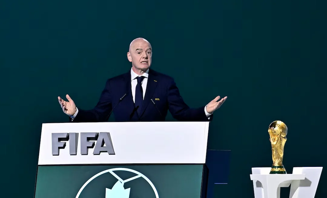 FIFA president Gianni Infantino beside the World Cup trophy